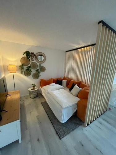 a bedroom with a bed and a couch at xiApartment in Höchst