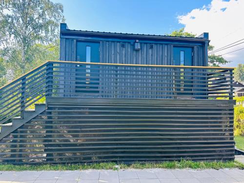 a house with a blue door and stairs at Studio house with sea view in Stockholm in Tyresö