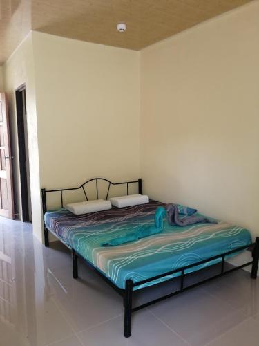 a bed sitting in a room with at Bluewaves Apartment in Dauis