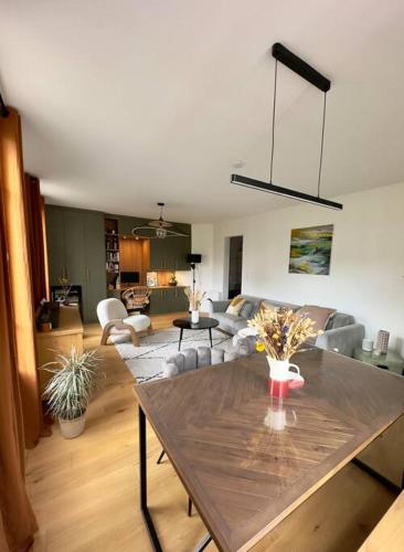 un salon avec une table avec des fleurs dessus dans l'établissement Appartement charmant - Batignolles/Montmartre, à Paris