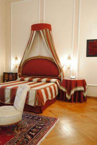 a bedroom with a king sized bed with a canopy at Park Hotel Villa Potenziani in Rieti
