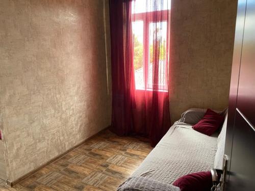 a small room with a bed and a window at Hotel Kobuleti in K'obulet'i