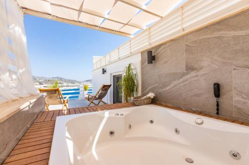 a bath tub in the bathroom of a house at Kalkan Saray Suites Hotel in Kalkan