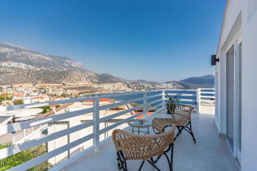 a balcony with chairs and a table with a view at Kalkan Saray Suites Hotel in Kalkan