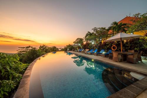 a swimming pool at a resort at sunset at Villa Selonding Batu in Lovina