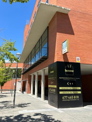 a brick building with a sign in front of it at AT home Avenida del Ejercito in Guadalajara