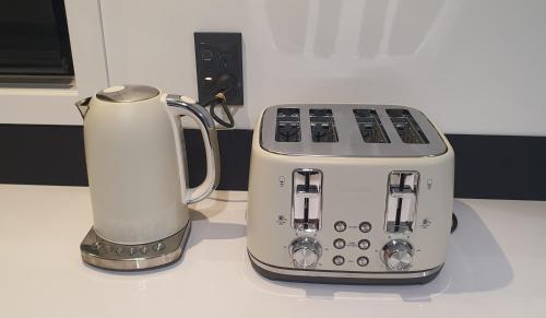 a toaster and a blender sitting on a counter at A Dreamed Home Away From Home in Rotorua