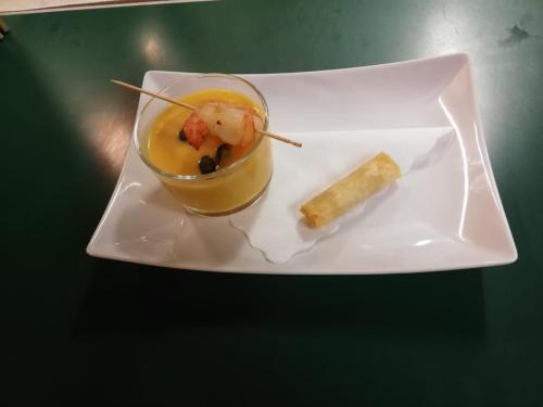 a plate of food with a drink and a stick at Landgasthof Heldenberg in Nenningen