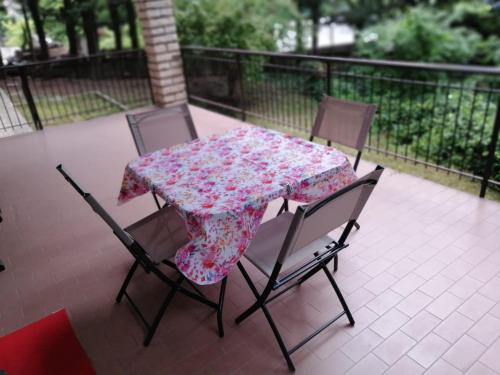 a table with a floral table cloth on a patio at House in the Mountains - greenery near Verona in Cerro Veronese