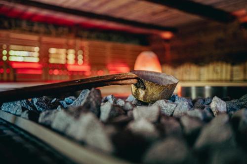 a wooden spoon in a pile of rocks at Cocoon - Alpine Boutique Lodge in Maurach