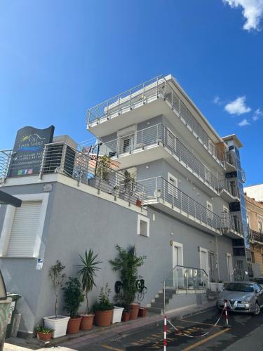 a building with a balcony on the side of it at Vista Mare Apartments in Giardini Naxos