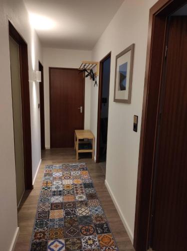 a hallway with a rug on the floor and a door at Gästewohnung WaSa in Hamm