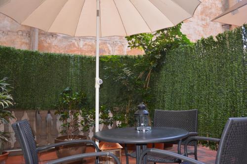a black table with an umbrella on a patio at Center Gran Via in Barcelona