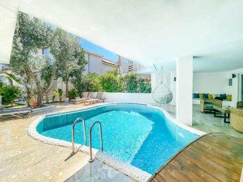 a swimming pool in the middle of a house at Kalkan Saray Suites Hotel in Kalkan