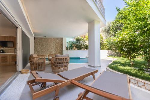 a living room with a table and chairs at Kalkan Saray Suites Hotel in Kalkan