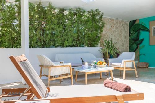 a patio with chairs and a table at Kalkan Saray Suites Hotel in Kalkan