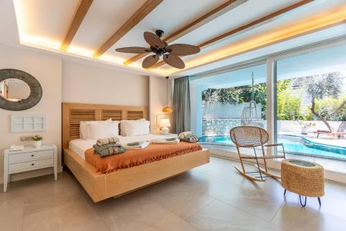 a bedroom with a bed and a ceiling fan at Kalkan Saray Suites Hotel in Kalkan