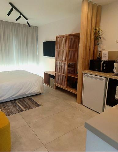 a bedroom with a bed and a desk with a microwave at Terrazza Suites in Paphos City