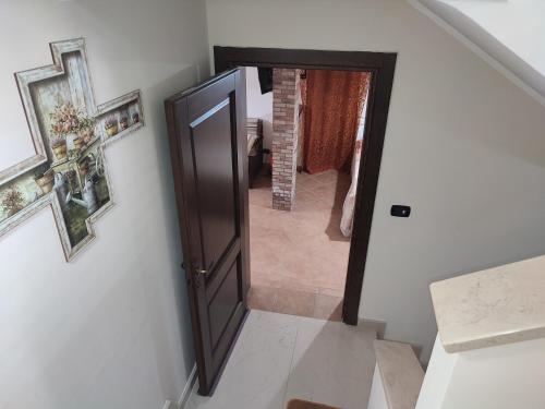 a hallway with an open door and a staircase at Sofia in Castro di Lecce