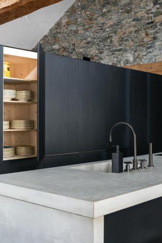 a kitchen with a sink and a counter top at Ein Kraftort und architektonisches Juwel in Ardez