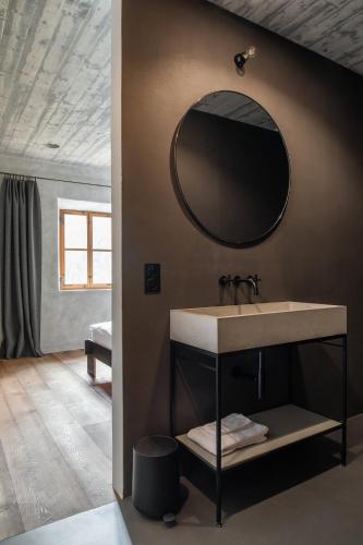 a bathroom with a sink and a mirror on the wall at Ein Kraftort und architektonisches Juwel in Ardez
