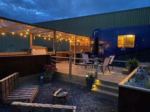a deck with a rv on top of a building at Horse Truck Tiny Home in Swords