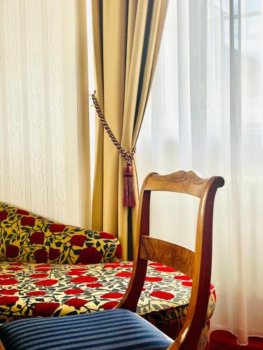 a chair and a couch in front of a window at Boutique-Hotel Amalienhof in Weimar
