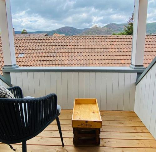 a bench and a wooden table on a balcony at Vintner Suites in Neustadt an der Weinstraße