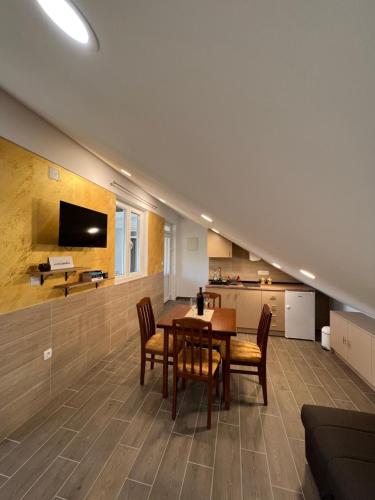 a dining room and kitchen with a table and chairs at Apartment ĆIRO in Herceg-Novi