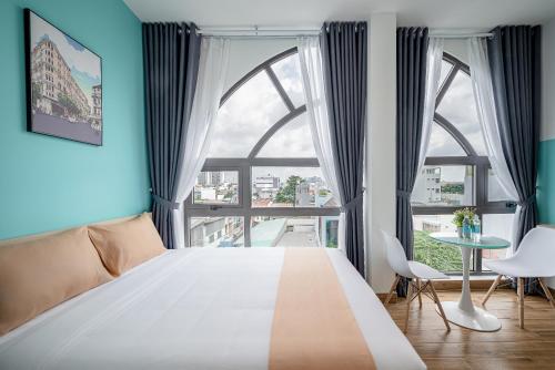 a bedroom with a large bed and a large window at Cozrum Homes - Cozytel Residence in Ho Chi Minh City