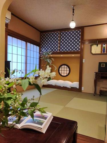 a room with a book on a table with a bed in it at 木香Mokkoh Modern Japanese style room by train15 minutes to Tokyo Station in Tokyo
