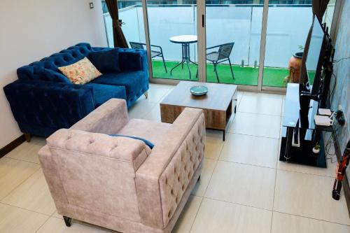 a living room with two chairs and a couch and a table at Luxury 2BR Apa- City Views at Skynest Residences in Nairobi