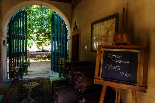 a chalkboard sign in a room with an open door at Villa Balis Crema Verona Hills in Grezzana