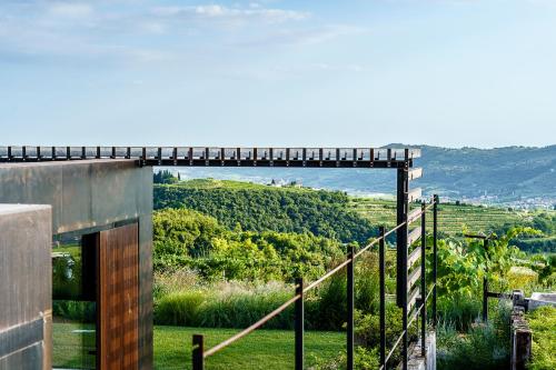 a building with a bridge with a view of a valley at Villa Balis Crema Verona Hills in Grezzana
