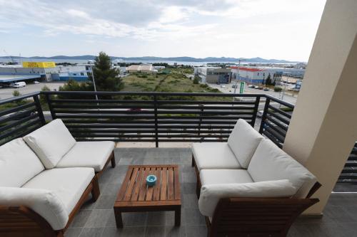 a balcony with two couches and a coffee table at D8 B&B in Zadar