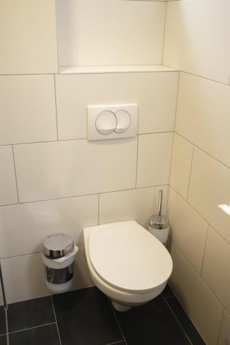 a bathroom with a white toilet and a trash can at D8 B&B in Zadar