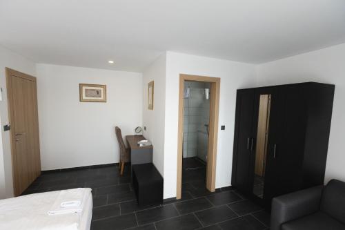 a living room with a couch and a bathroom at D8 B&B in Zadar