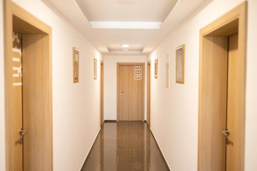 a corridor of a hospital hallway with doors and tile floors at D8 B&B in Zadar