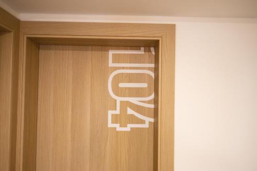 a wooden door with the word roar written on it at D8 B&B in Zadar