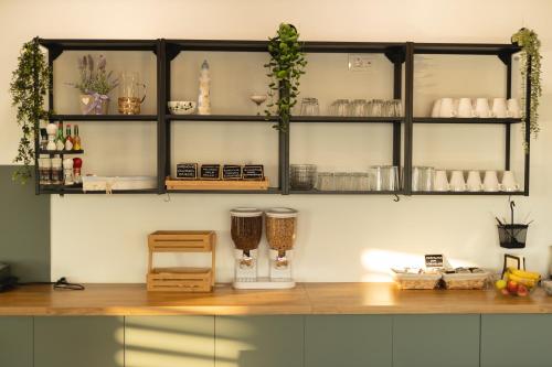 a room with a counter with shelves and some cups at D8 B&B in Zadar