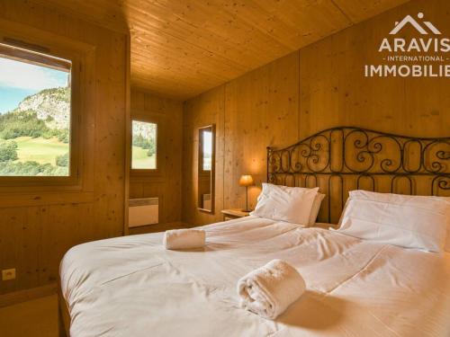 a bedroom with a large white bed with a window at Appartement Le Grand-Bornand, 3 pièces, 4 personnes - FR-1-391-103 in Le Grand-Bornand