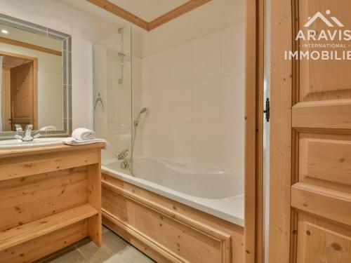a bathroom with a tub and a shower and a sink at Appartement Le Grand-Bornand, 3 pièces, 4 personnes - FR-1-391-103 in Le Grand-Bornand
