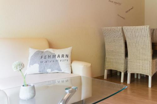 a room with two chairs and a pillow on a table at Meislahnhof Fehmarn in Fehmarn