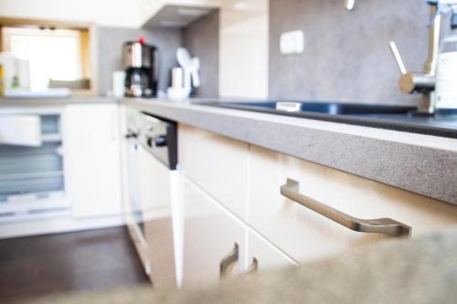a kitchen with white cabinets and a counter top at Meislahnhof Fehmarn in Fehmarn