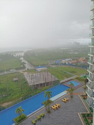 a view of a resort with a swimming pool at Mactan Newtown Beach Condo in Mactan