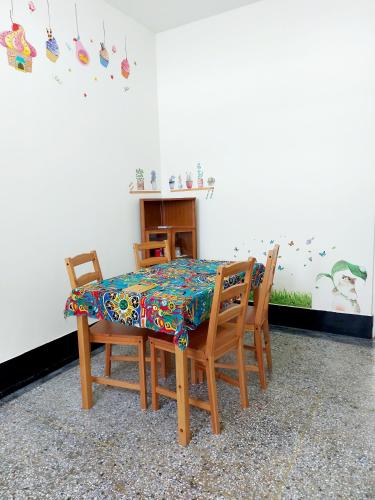 a dining room table with two chairs and a colorful table cloth at 老宅小巷6人包棟民宿 in Taitung City