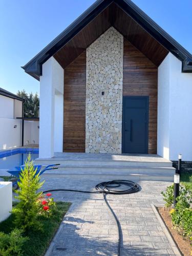 a house with a blue door and a patio at Villa deluxe in Baku