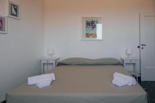 a bedroom with a bed with two towels on it at [La Terrazza di Chiavari] in Chiavari