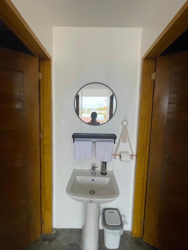 a bathroom with a sink and a mirror at Sunset Paradise Moalboal in Moalboal