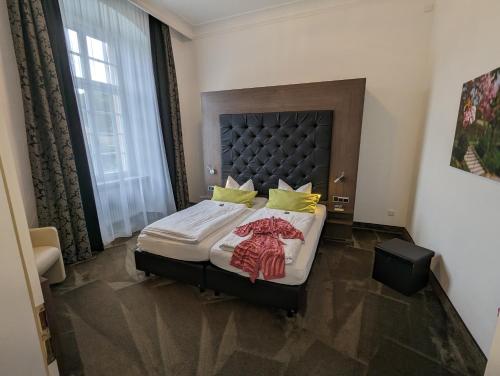 a bedroom with a large bed with a large window at Badhotel Bad Brückenau in Staatsbad Brückenau